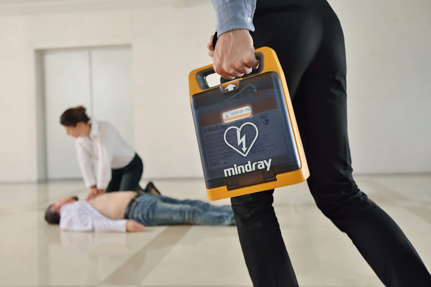 Responder carrying a Mindray BeneHeart AED to an emergency