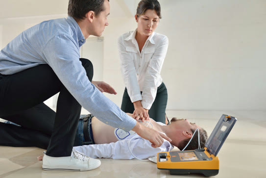 Bystanders performing CPR with an AED